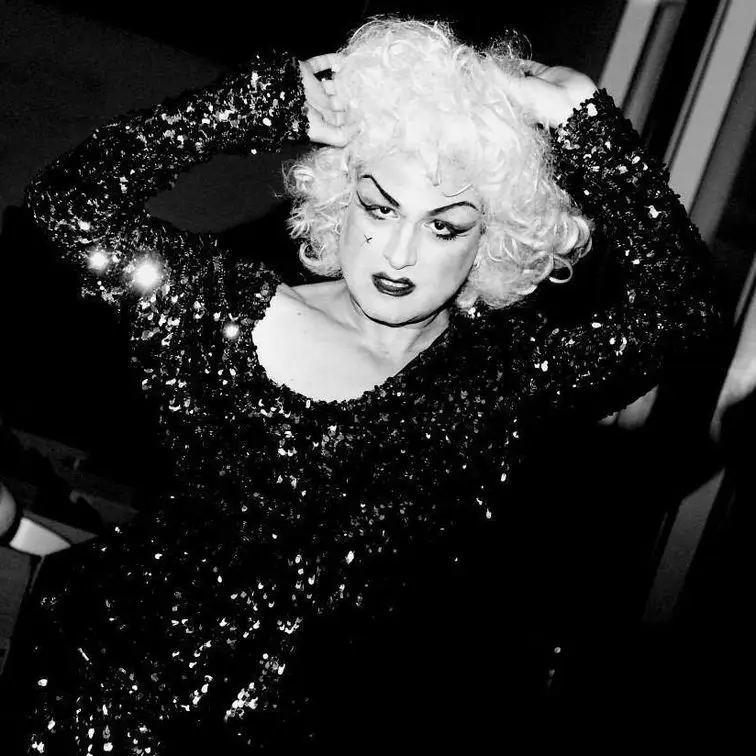 Anita posing glamourously in a sparkling dress